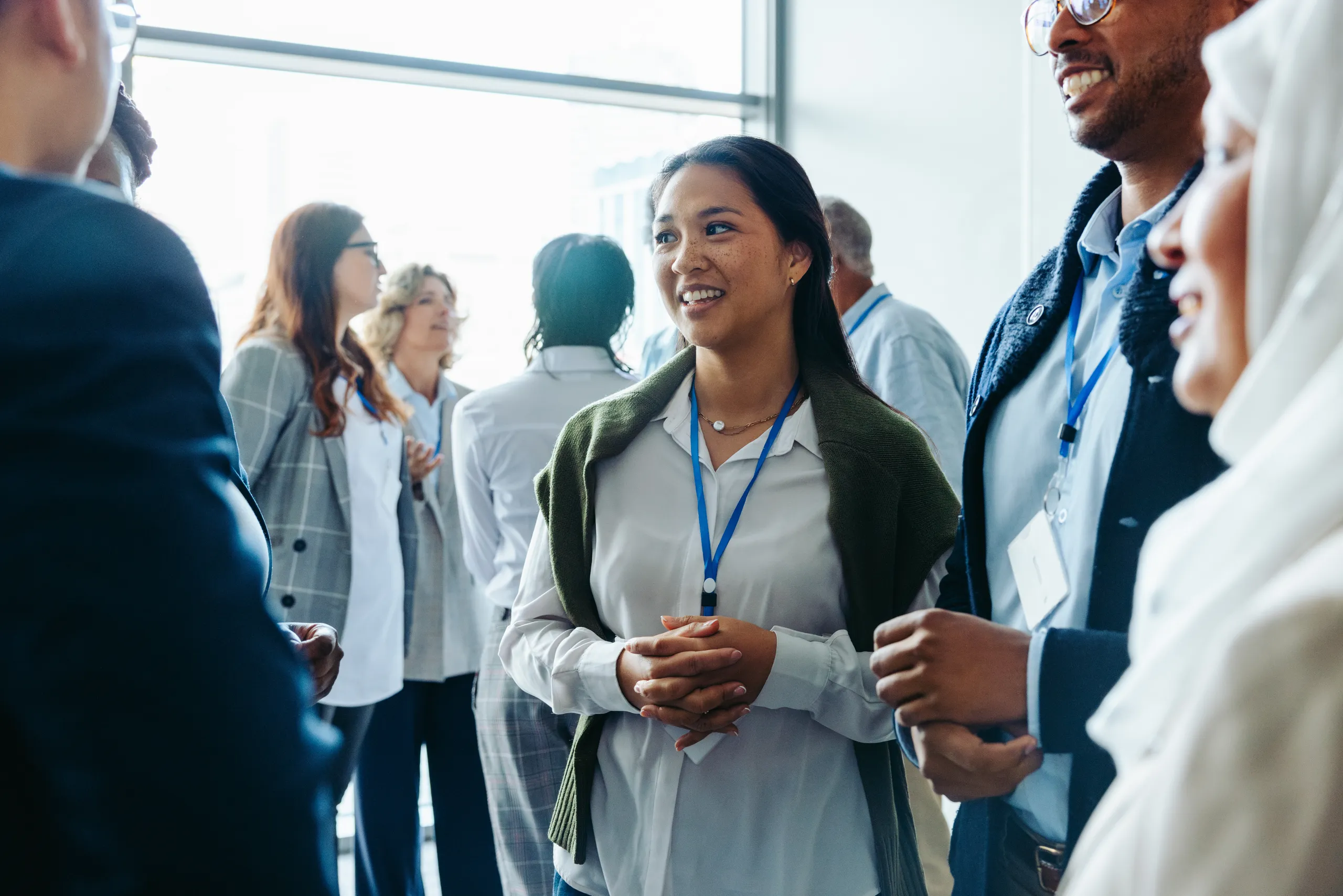 Researchers and colleagues in conversation at a professional gathering.