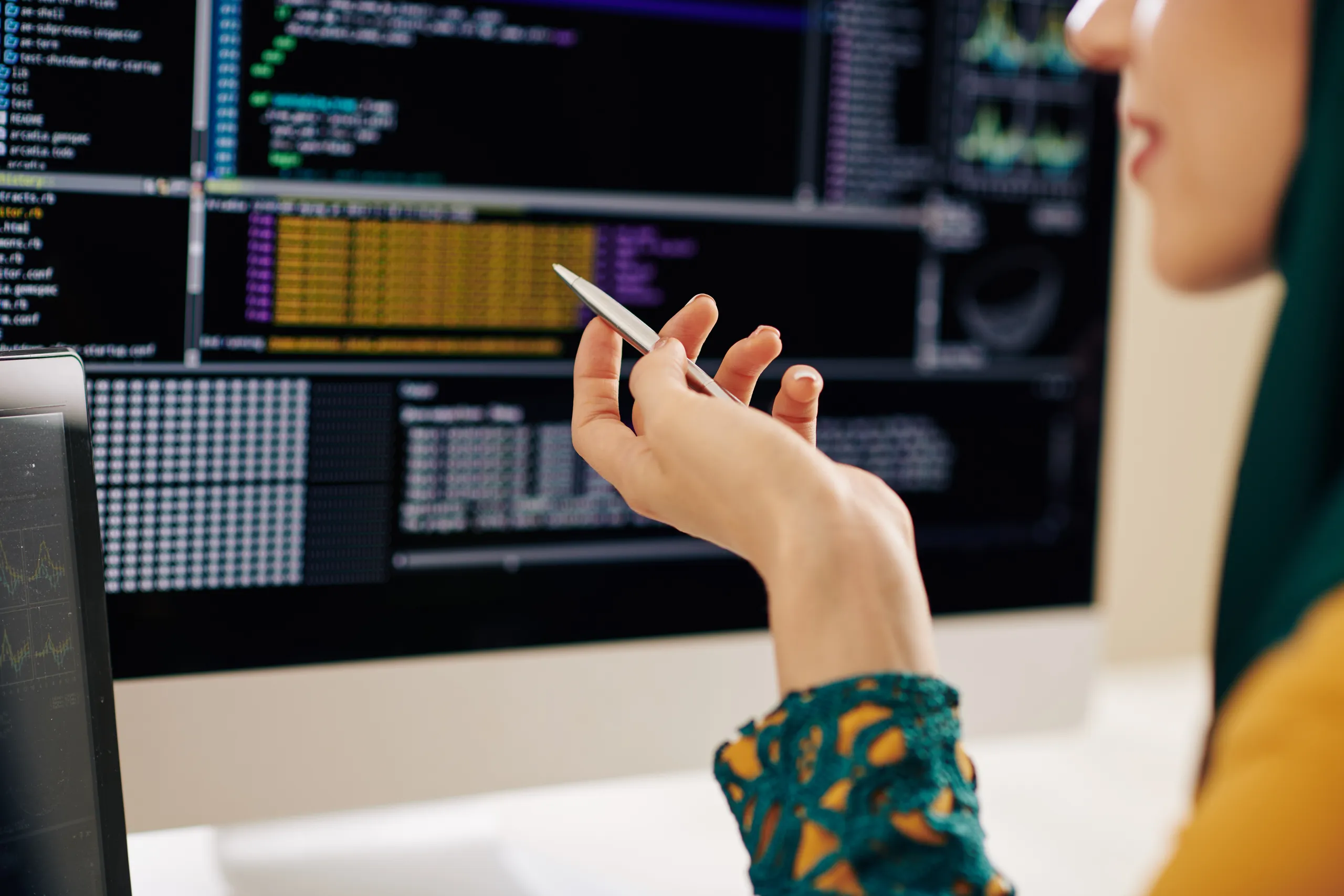 A researcher reviewing data on screens