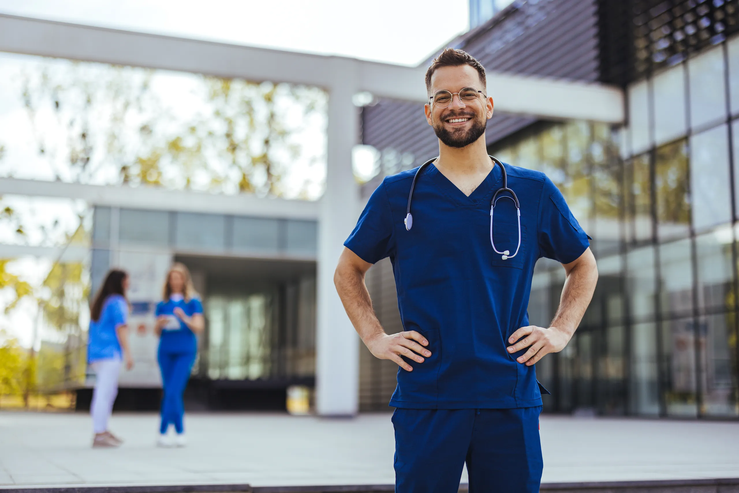 A healthcare worker outside a hospital building