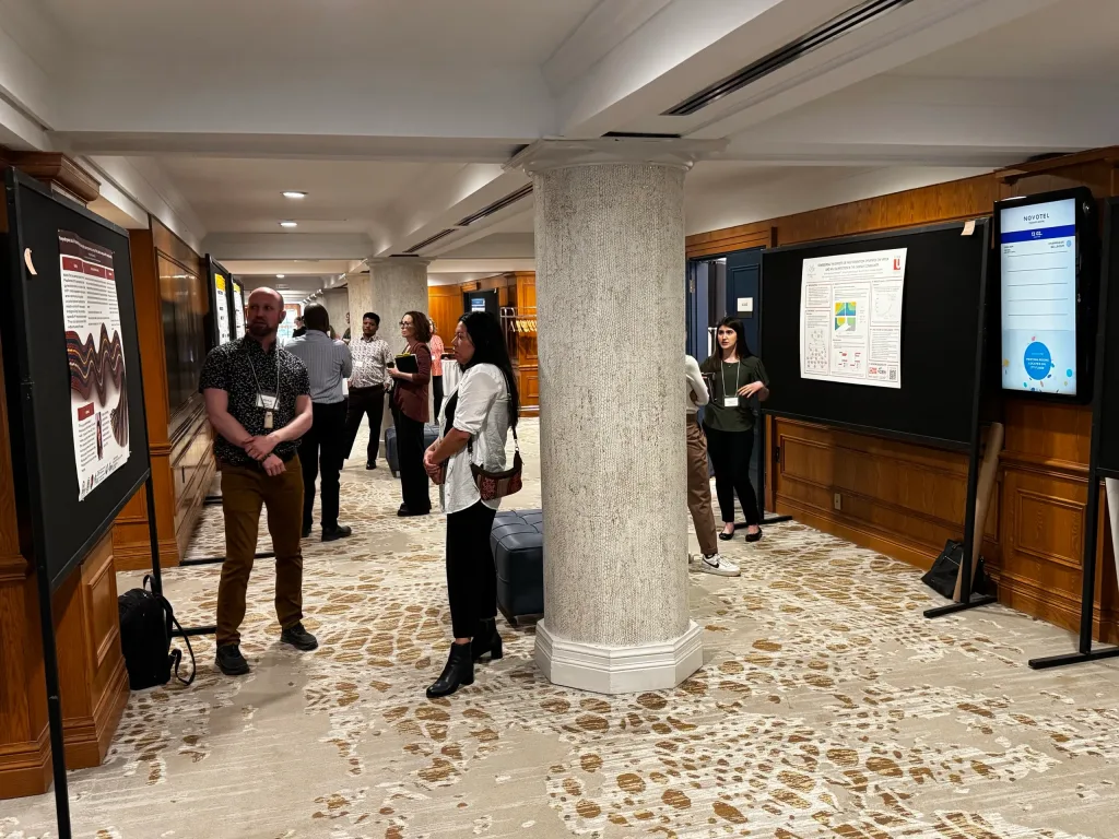 Attendees viewing research posters in the foyer at the 2025 CIRN Annual General Meeting, Novotel Toronto Centre