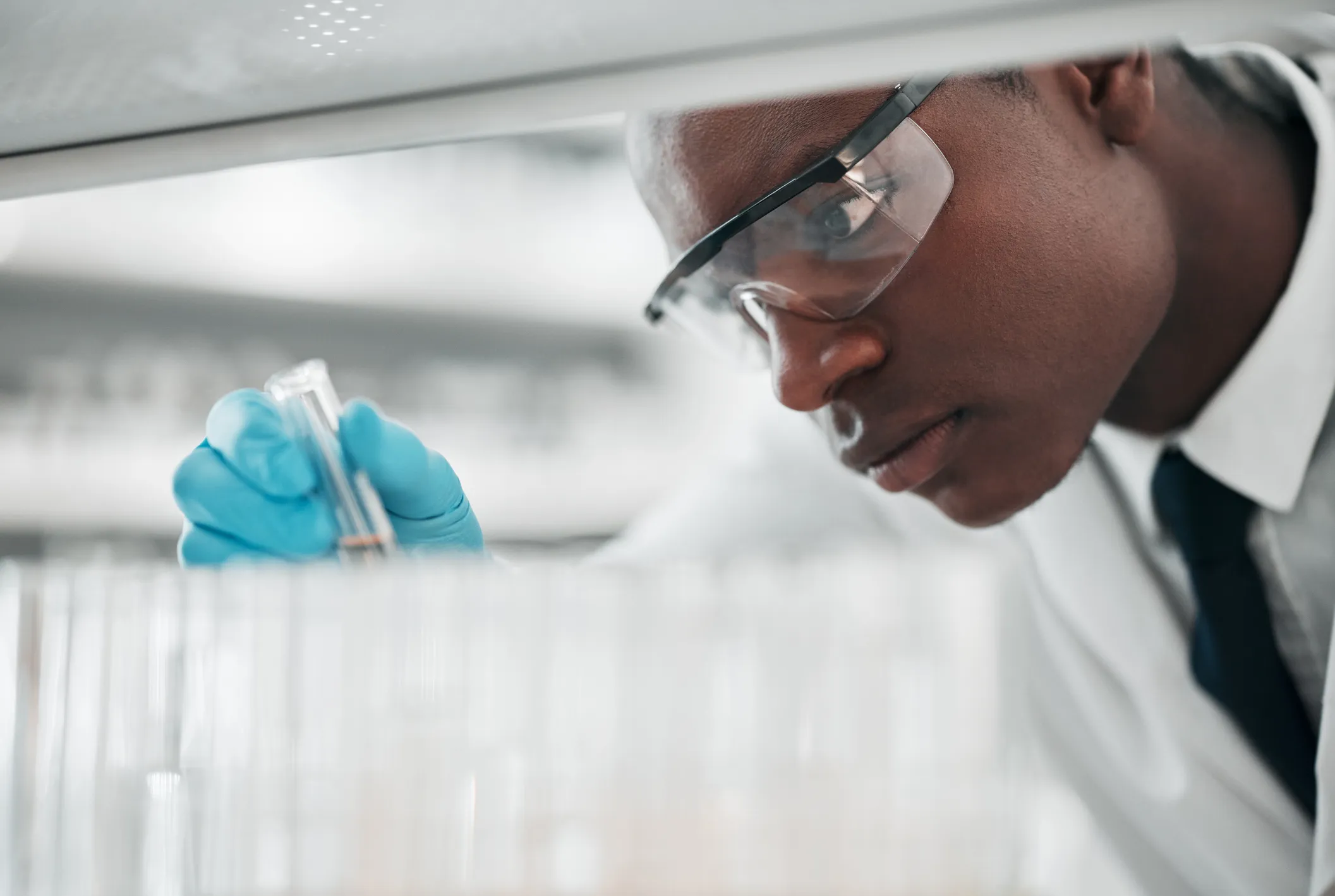 A researcher examining a sample in the laboratory